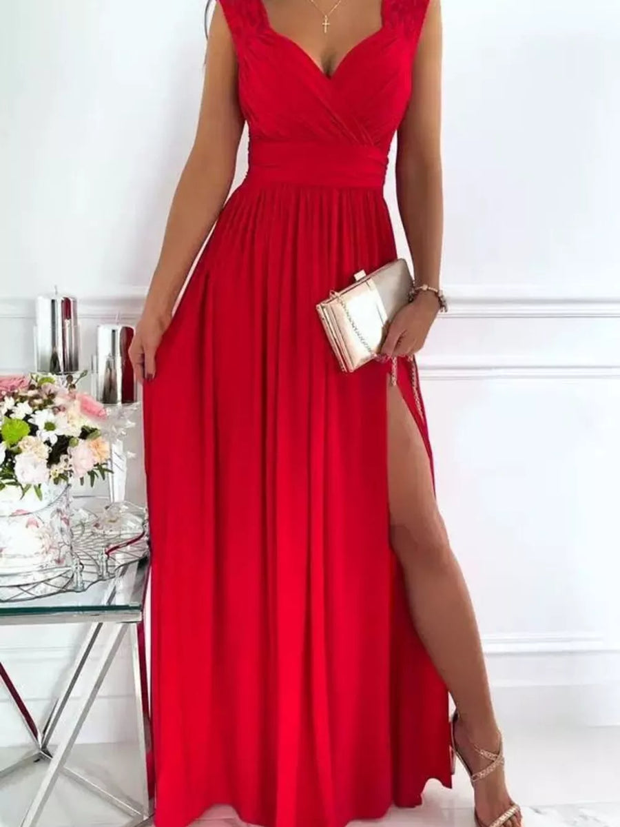 Scarlet maxi dress with lace neckline and high slit, styled with a clutch.