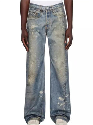 Artisan distressed wide-leg denim jeans in medium wash with paint splatters and a relaxed fit.