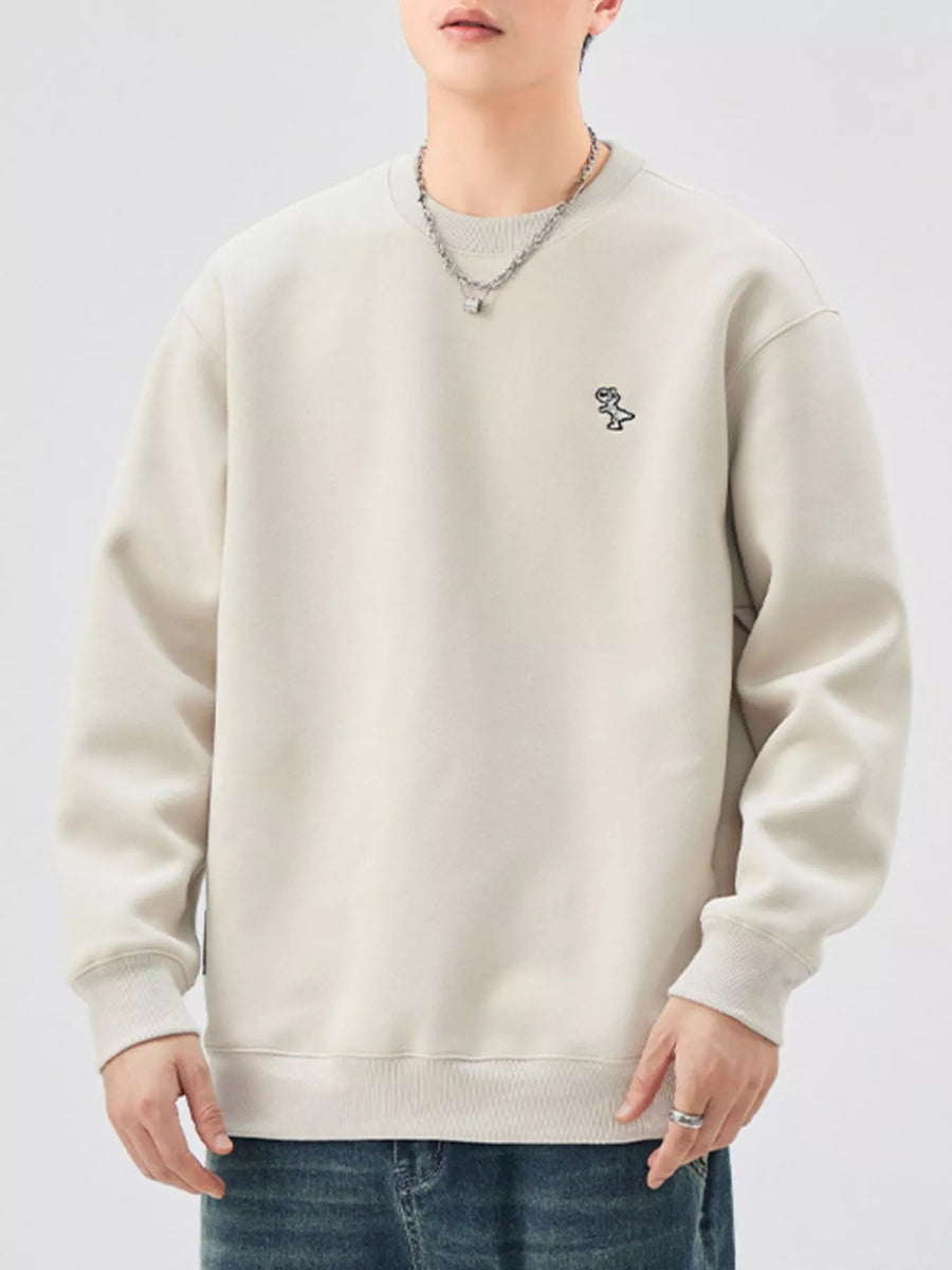 Plus-size long-sleeve sweatshirt in light beige with embroidered dinosaur graphic on chest.