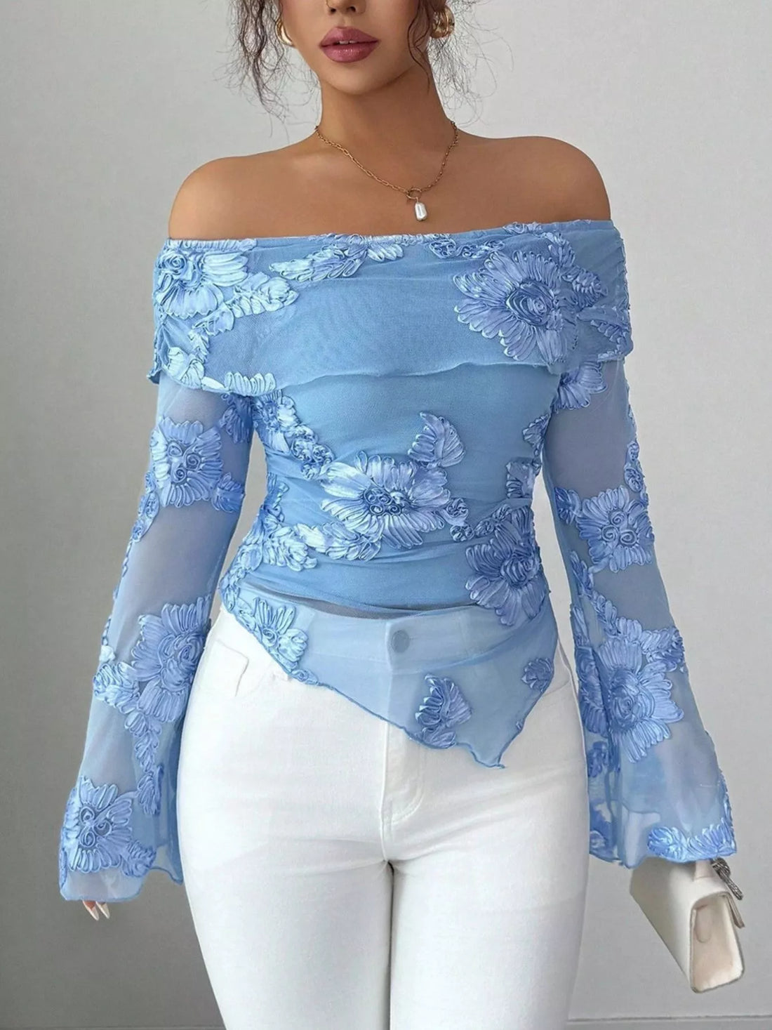 Sky blue floral ruffled off-shoulder blouse with sheer sleeves and asymmetrical hem.