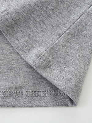 Toddler grey cotton t-shirt detail showing seams and hem.