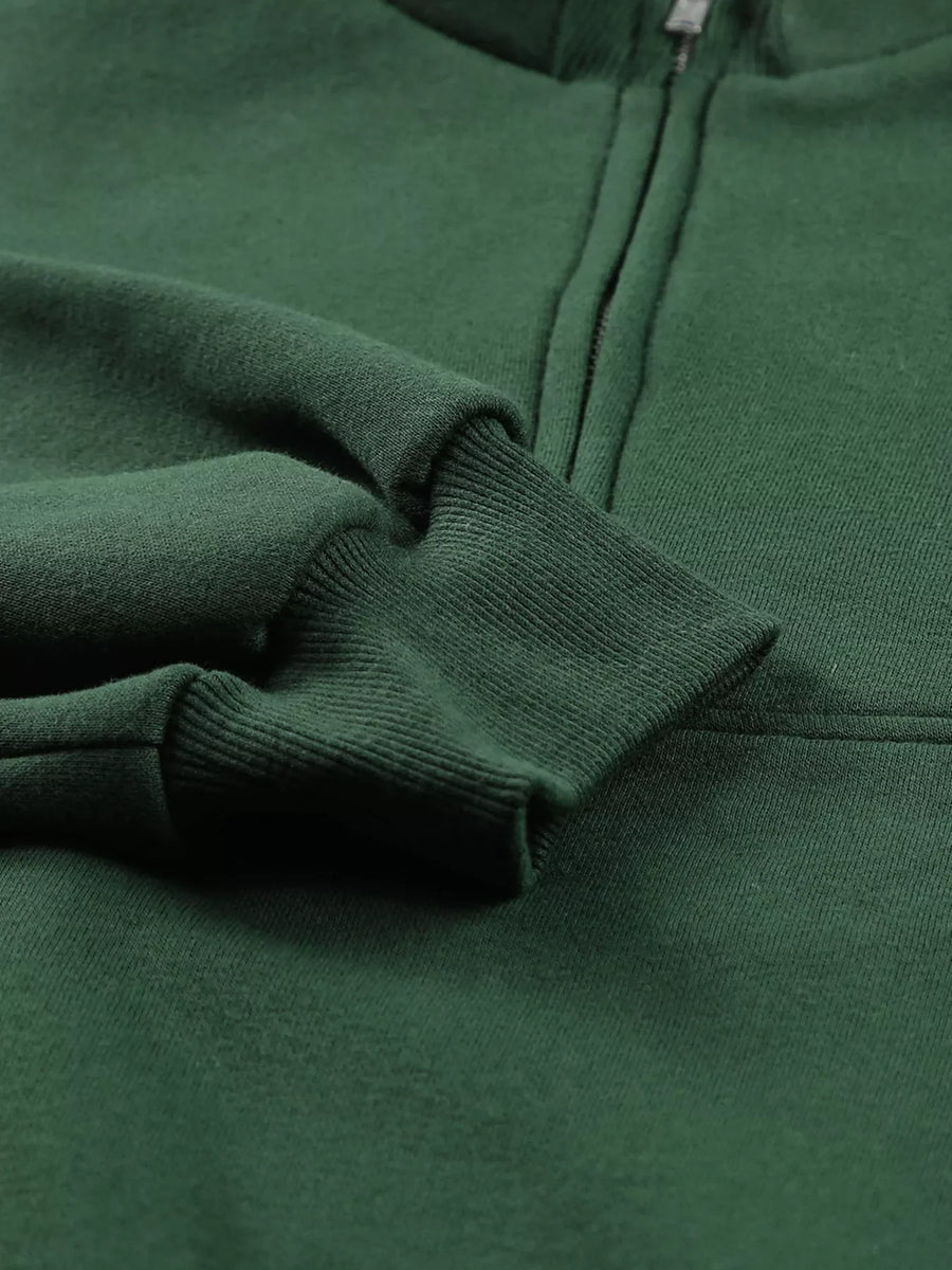 Dark green half zip sweatshirt with stand collar and ribbed cuffs.