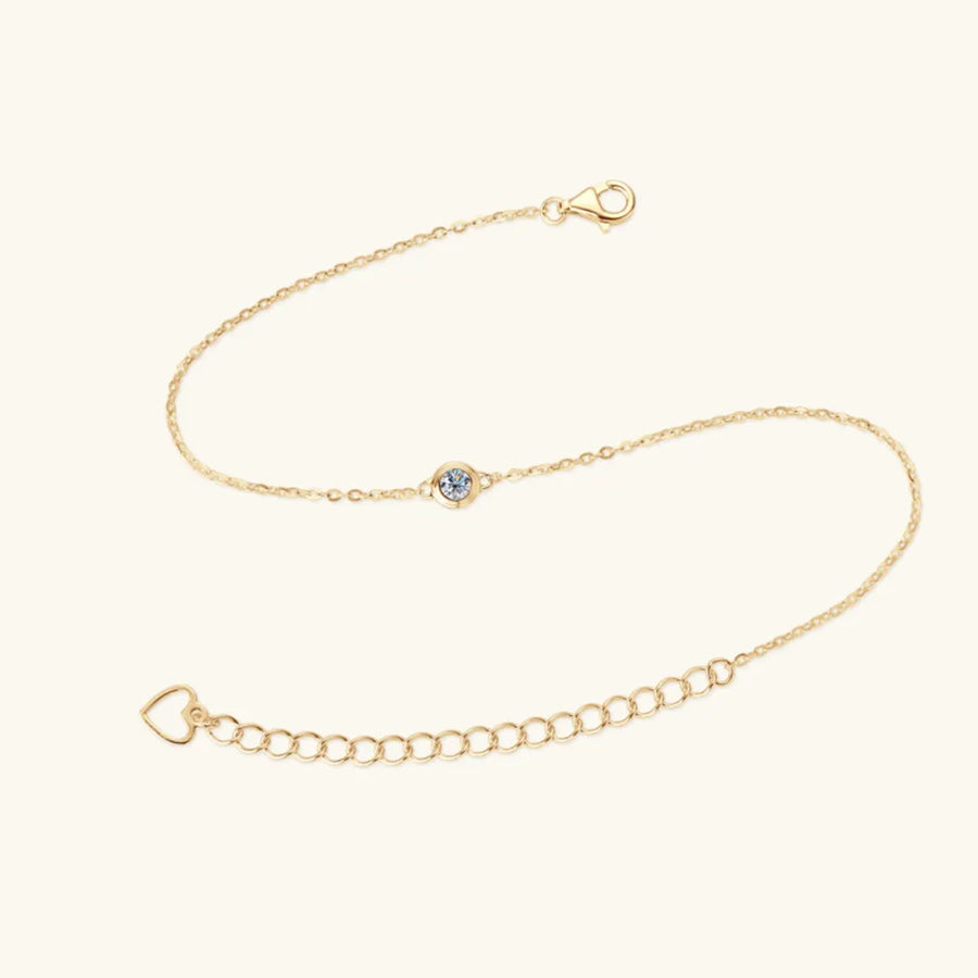 Gold moissanite solitaire chain bracelet with heart charm and adjustable clasp.