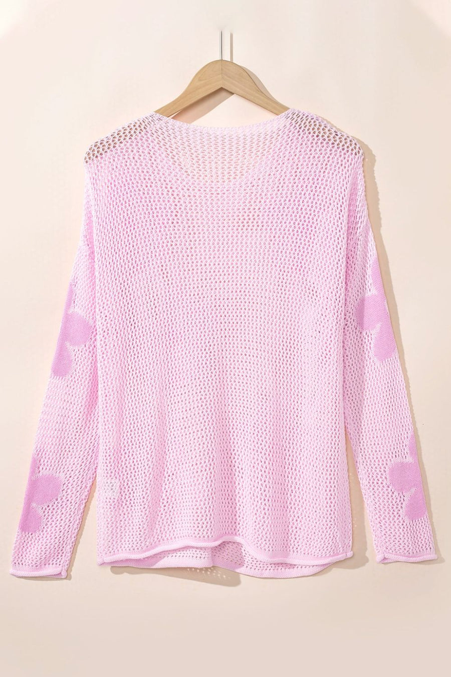 Blush pink openwork sweater with floral intarsia pattern on sleeves, acrylic knit.