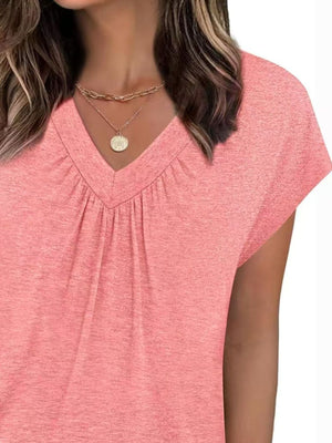Pink ruched v-neck t-shirt with short sleeves and a relaxed fit.