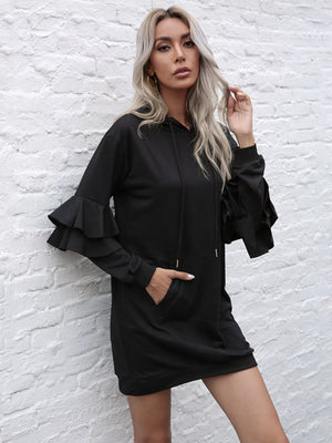 Black hooded mini dress with ruffle trim sleeves and a front pocket.