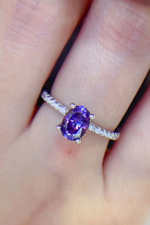 Amethyst oval pavé ring with a bright purple stone and diamond accents.