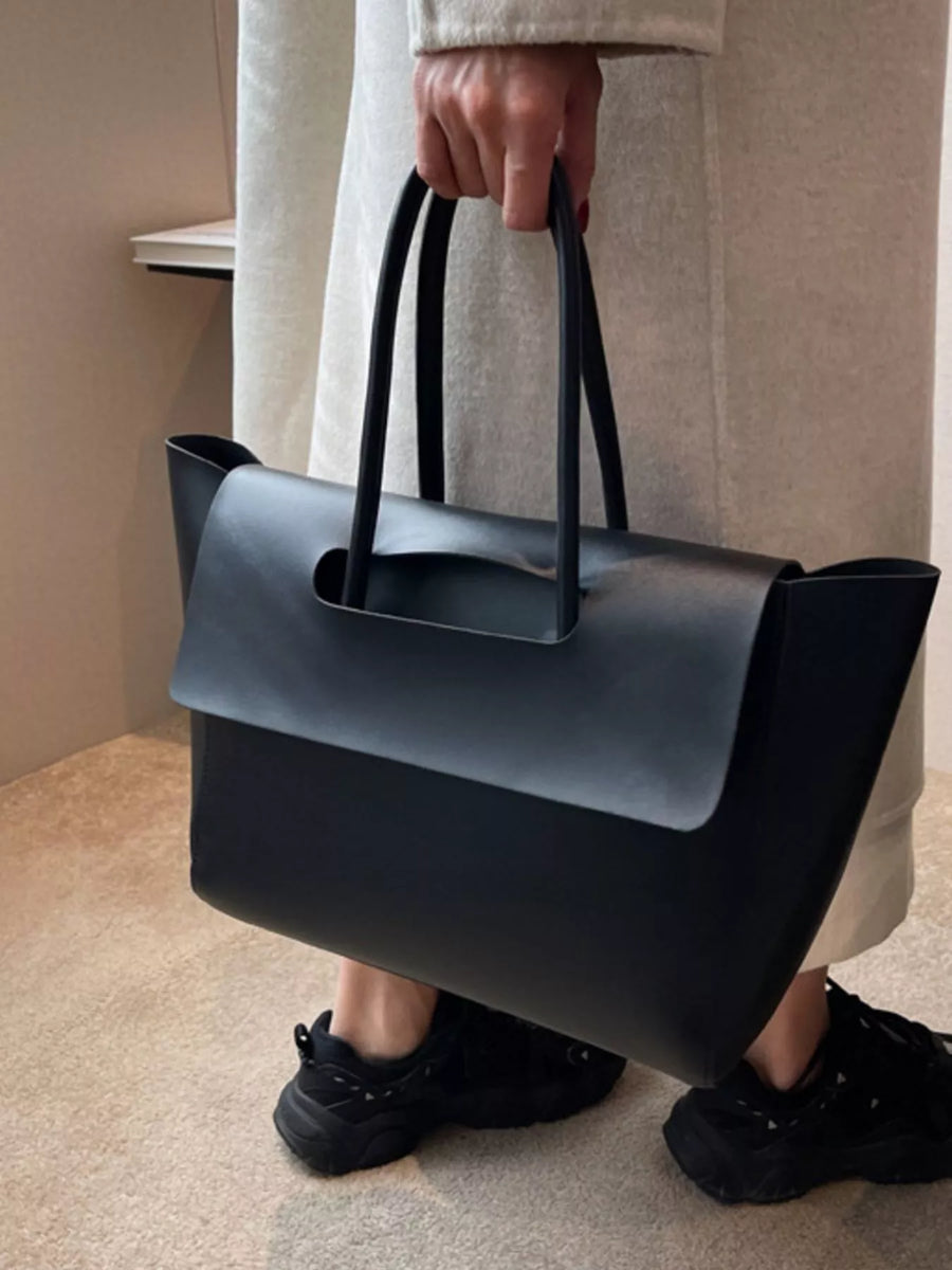 Black PU leather tote shopper bag with top handles and a fold-over flap detail.
