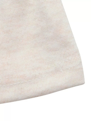 Cream knit fabric with subtle pink marled texture and visible stitching detail.