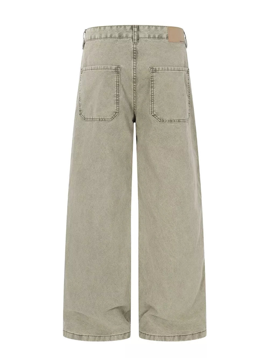 Two-tone wide-leg cargo pants in khaki color with distressed details and large back pockets.