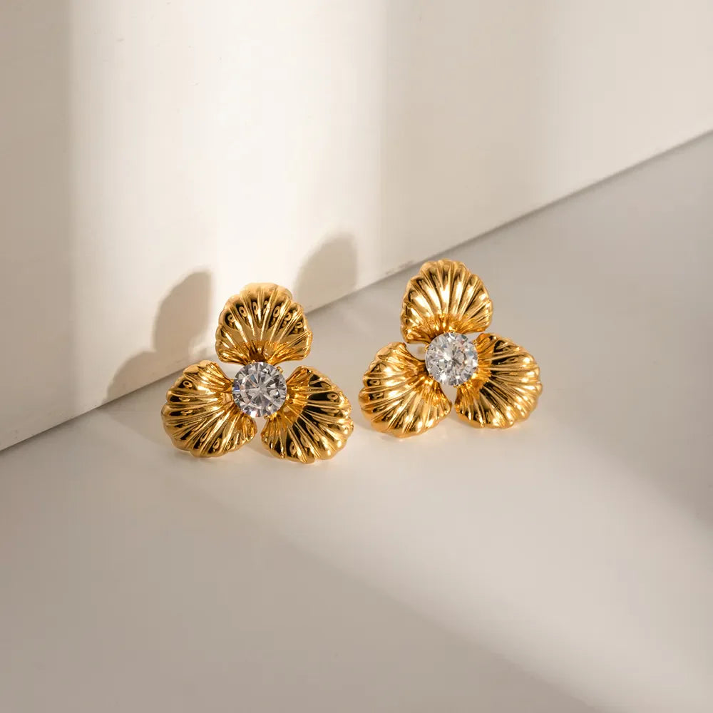 Gold petal stud earrings with clear crystal centers