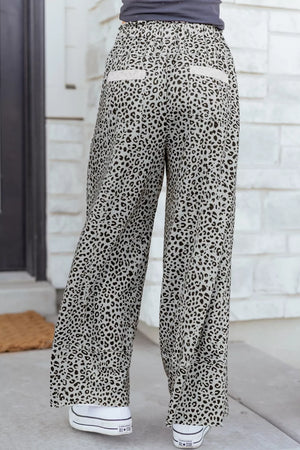 Animal print wide leg pants with drawstring waist and back pockets.