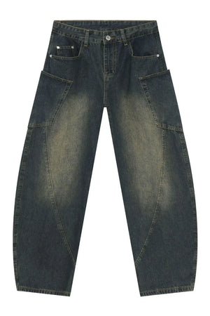 Dark wash denim balloon trousers with unique paneling and a relaxed fit.