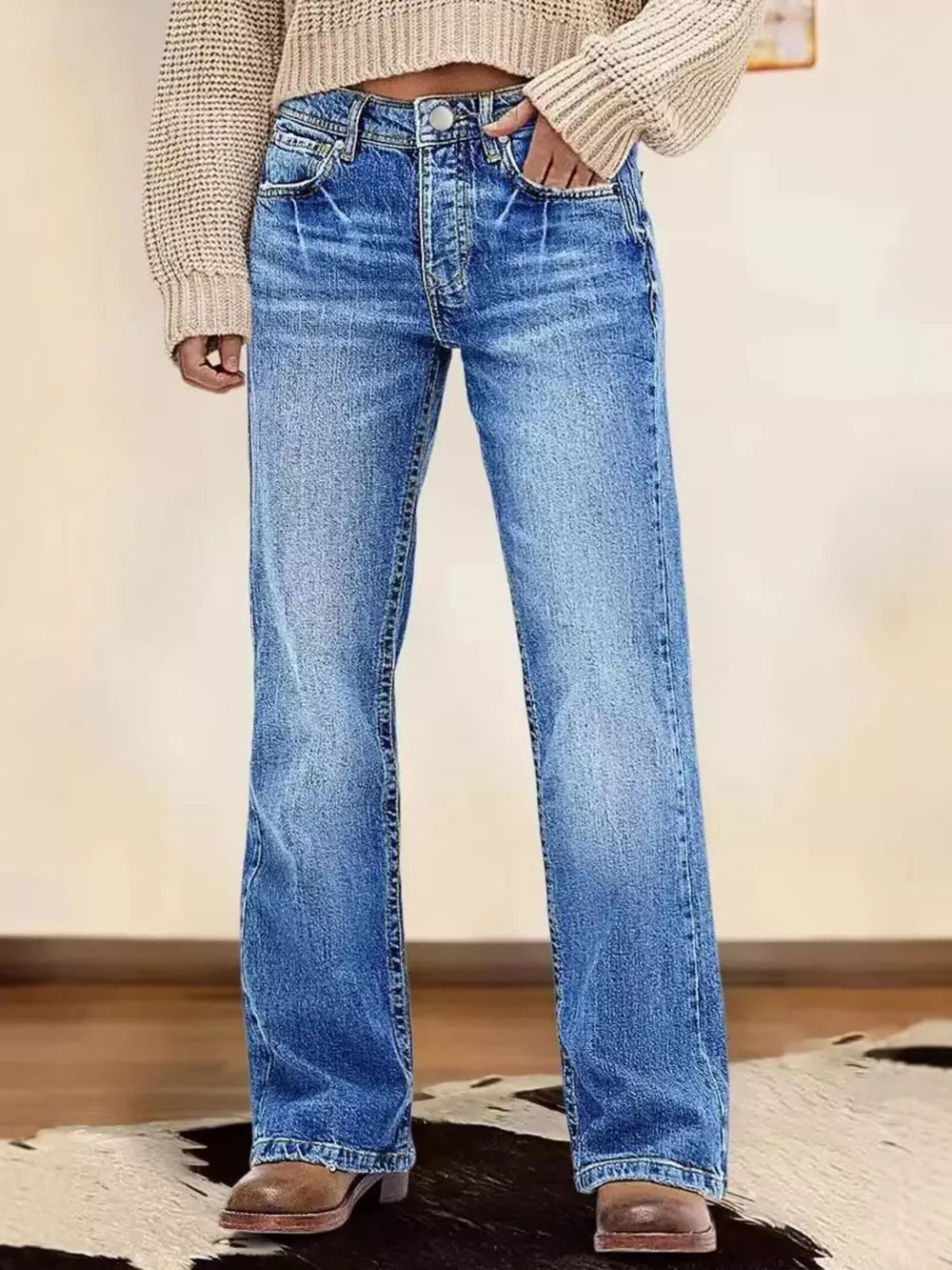 Light blue vintage wash straight leg denim jeans with button fly and whiskering detail.