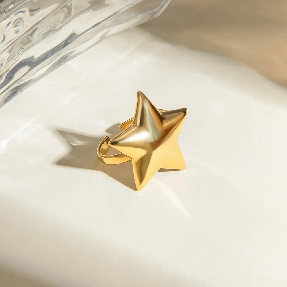 Gold starburst adjustable ring with a bold, sculpted design.