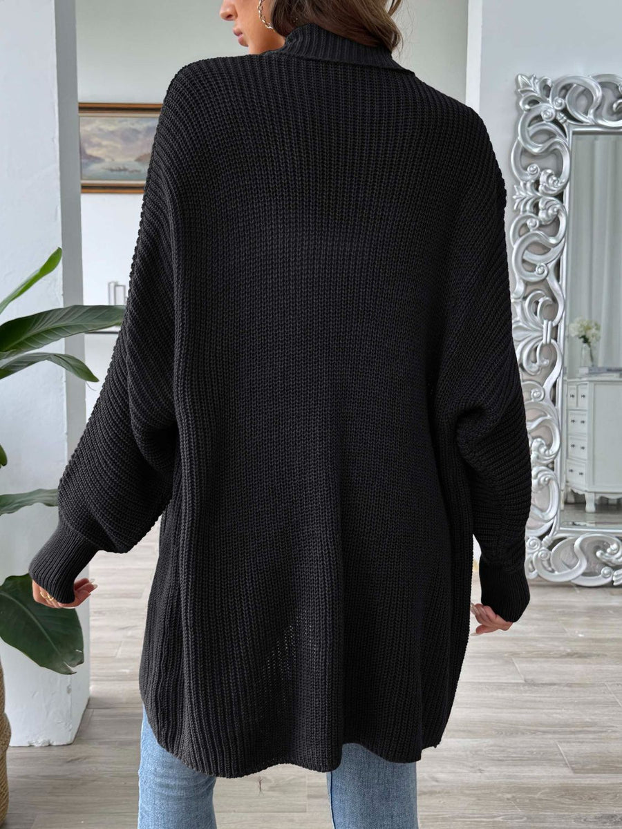 Black ribbed knit cocoon cardigan with a high neck and balloon sleeves.