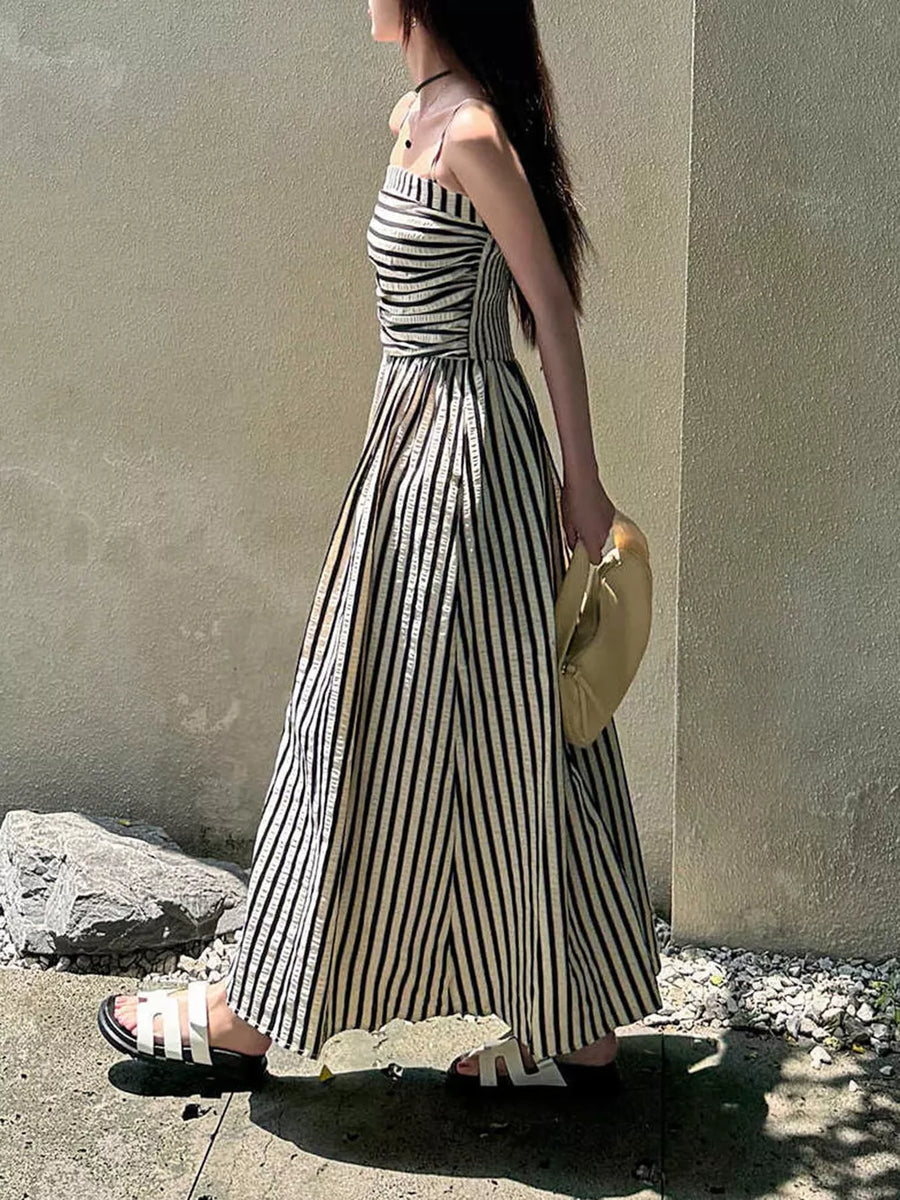 Black and white striped maxi dress with spaghetti straps and a thigh-high slit.