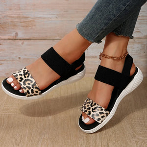 Geometric print elastic strap sandals with leopard print detail and black straps.