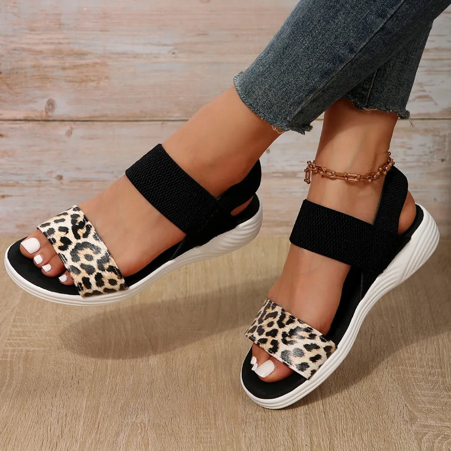 Geometric print elastic strap sandals with leopard print detail and black straps.