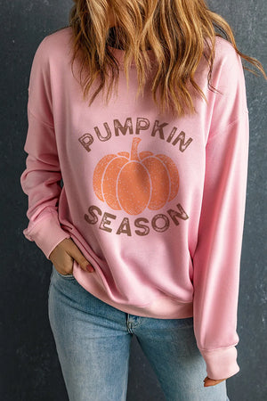 Pink crewneck sweatshirt with pumpkin graphic and text reading Pumpkin Season