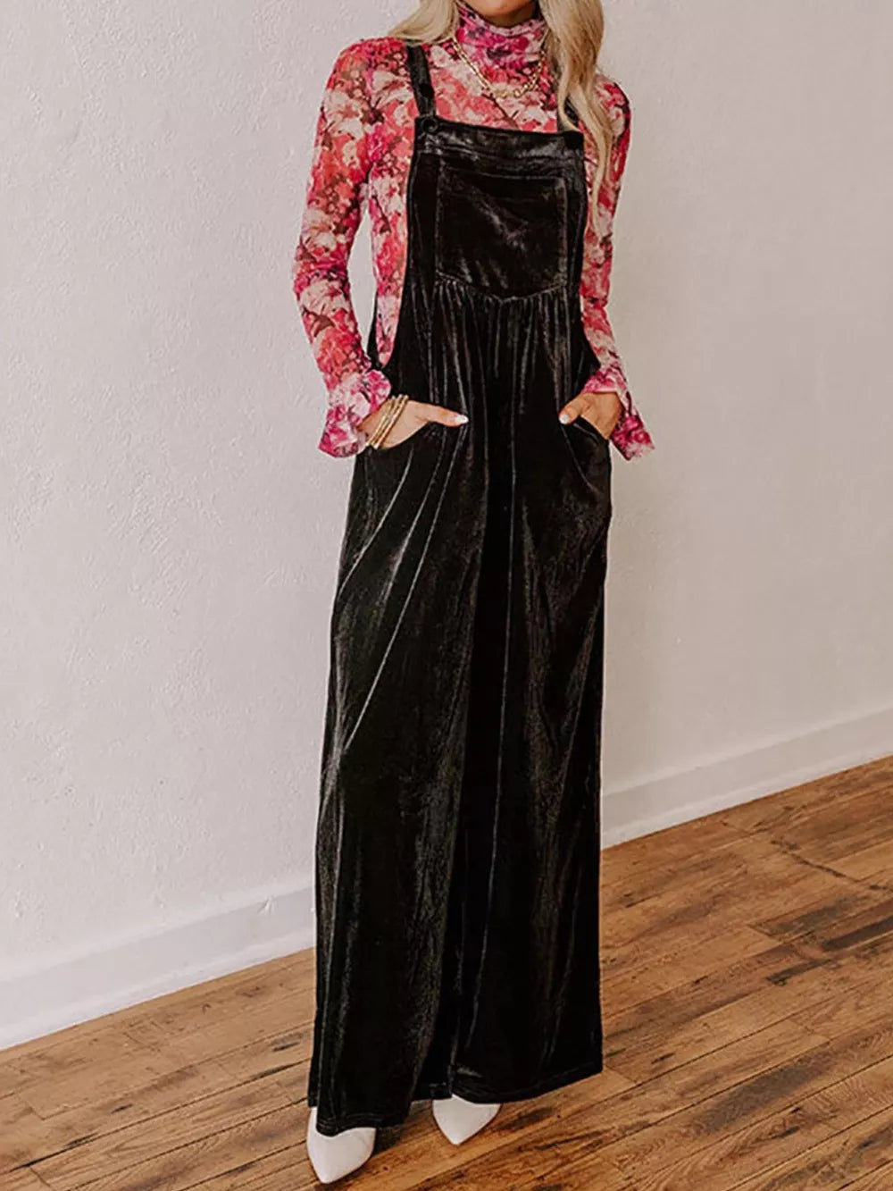 Black velvet wide-leg maternity overalls with pockets, styled with a floral top.