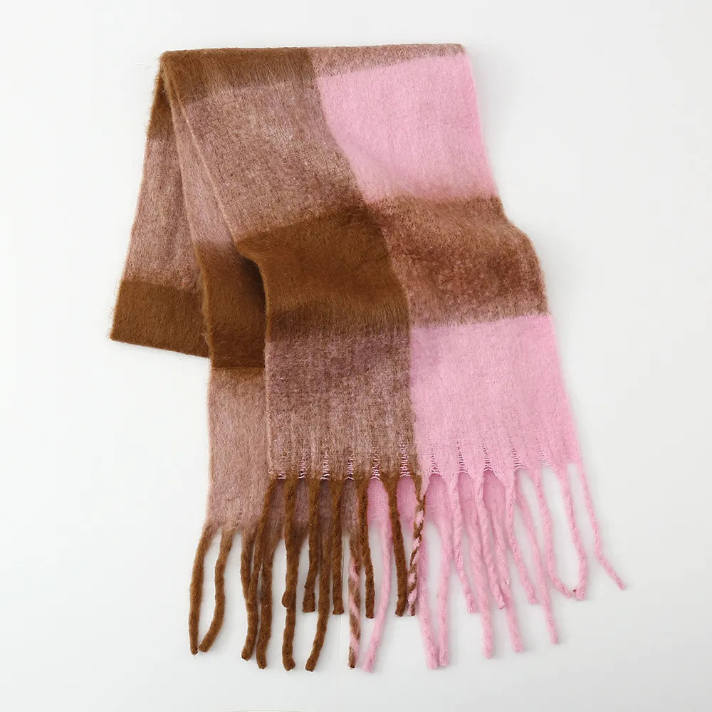 Fluffy plaid scarf with fringe in pink and brown color blocks.