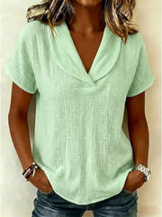 Light green textured blouse with a V-neck and short sleeves, styled casually.