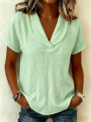 Light green textured blouse with a V-neck and short sleeves, styled casually.