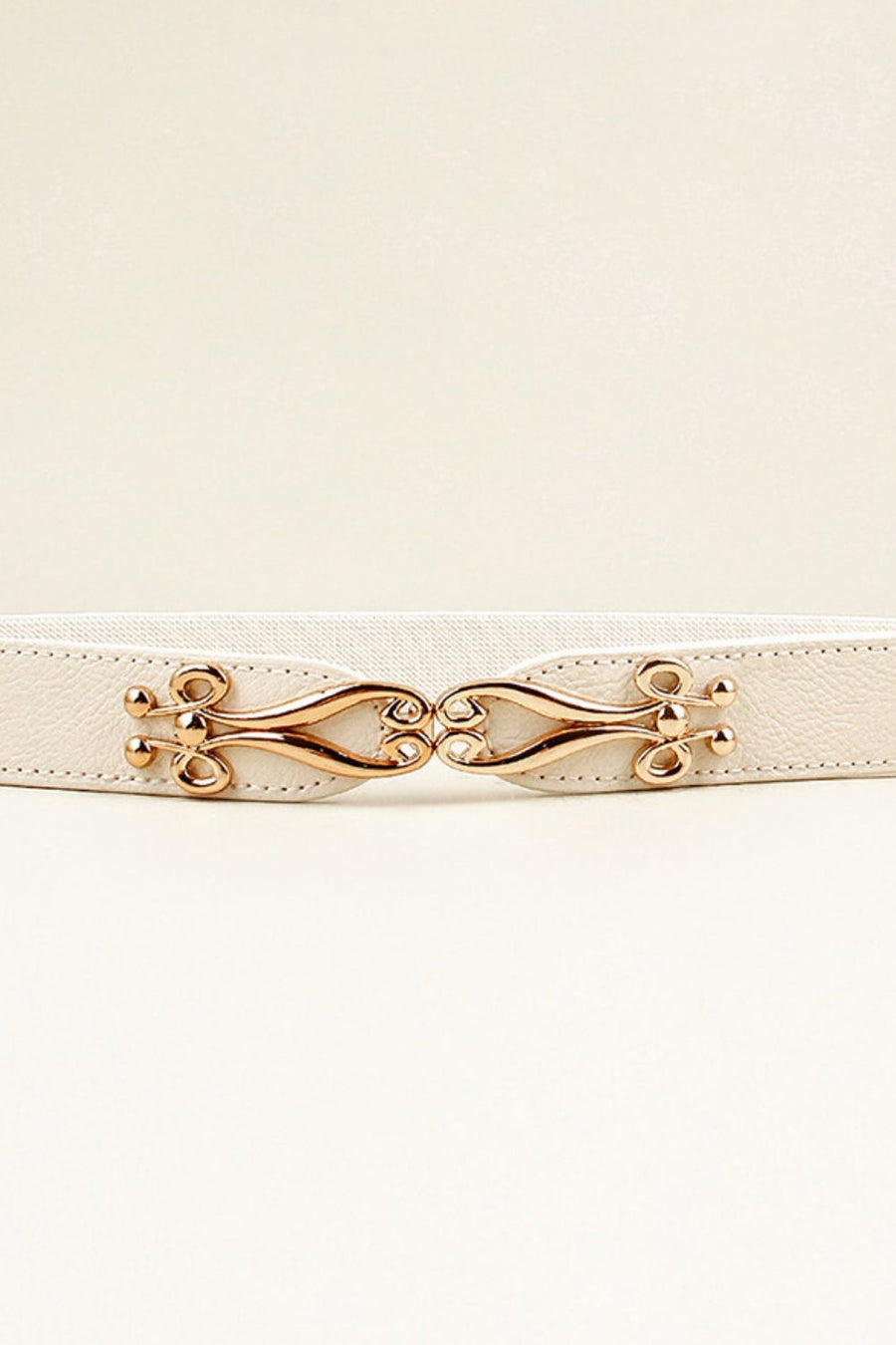 White elastic waist belt with sculpted gold alloy clasp and decorative studs