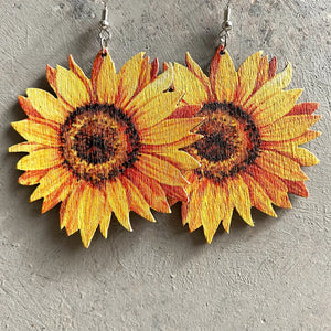 Sunflower drop earrings with detailed yellow and orange petals and brown centers.