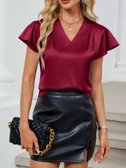 Burgundy satin V-neck blouse with flutter sleeves and a draped bodice.