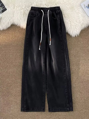 Black wide-leg drawstring jeans with a relaxed fit and denim material.