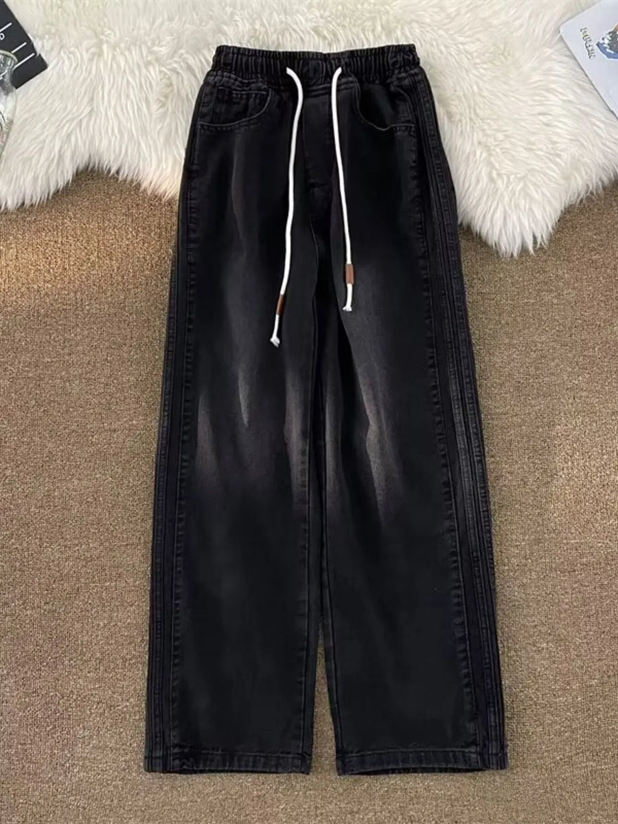 Black wide-leg drawstring jeans with a relaxed fit and denim material.