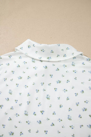 White collared shirt with a blue floral print and green stems