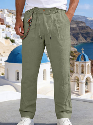 Olive green linen blend drawstring pants with a relaxed fit and decorative chain detail
