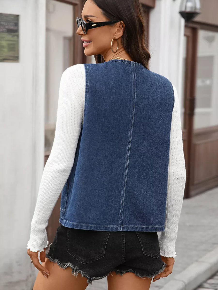 Blue denim vest with collarless neckline and button-down front, shown from the back.