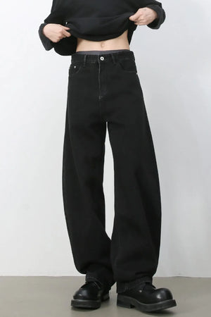 Black denim balloon trousers with a high waist and wide leg.