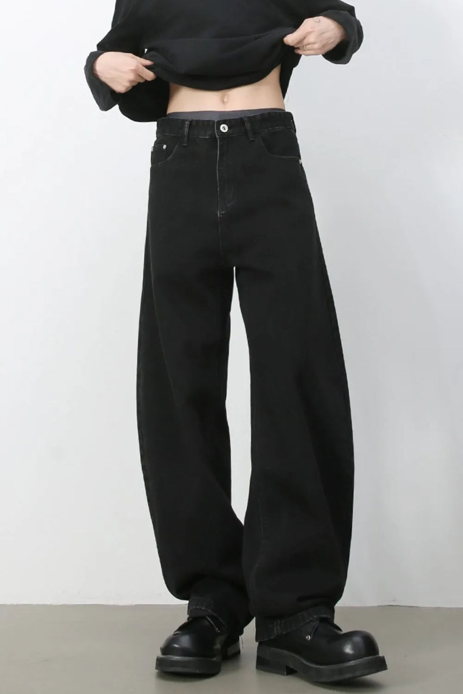 Black denim balloon trousers with a high waist and wide leg.