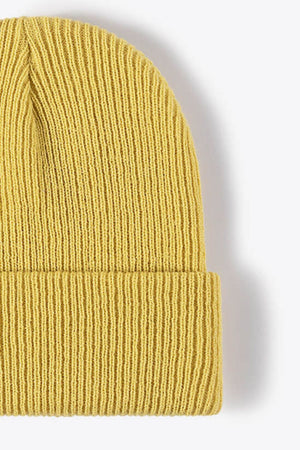 Yellow ribbed knit beanie with a cuffed hem.