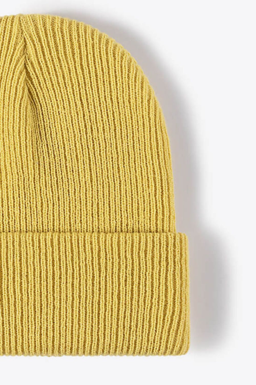 Yellow ribbed knit beanie with a cuffed hem.