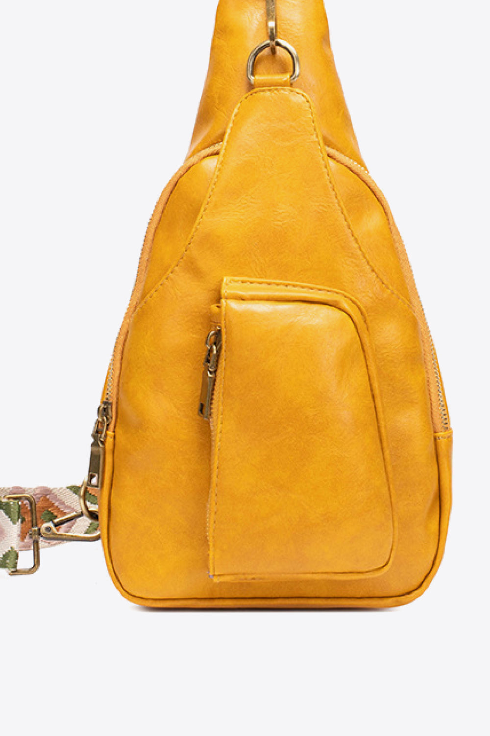 Yellow textured sling bag with woven strap detail and front zip pocket.