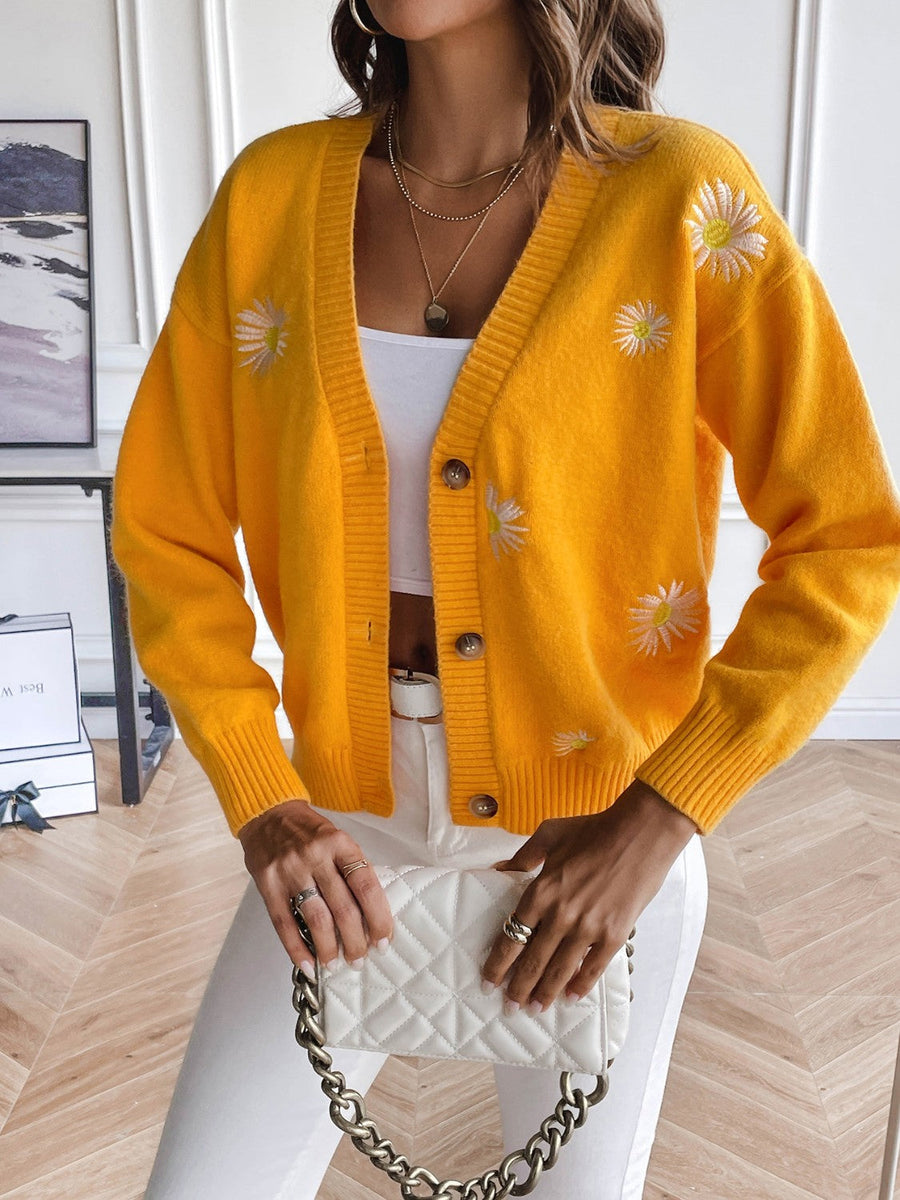 Gold button-down cardigan with embroidered daisies and ribbed trim.