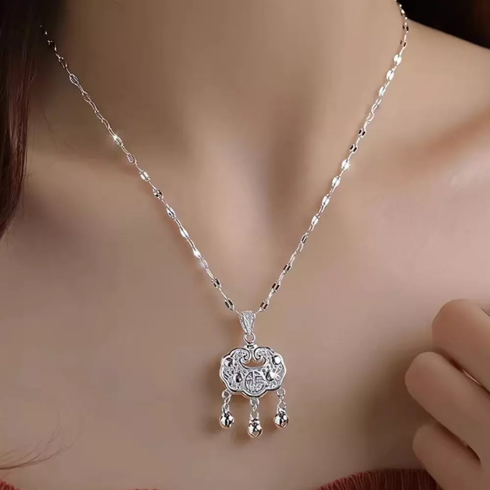 silver necklace with ornate and not applicable