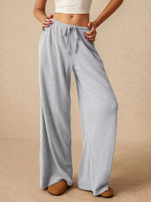Gray ribbed wide-leg drawstring pants with a relaxed fit.