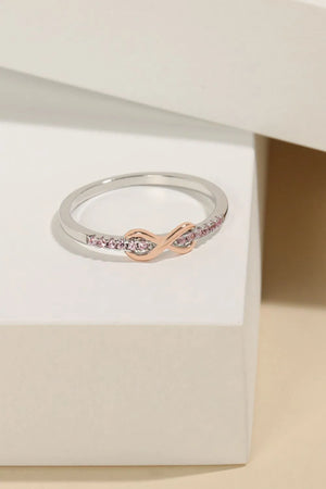 Silver ring with rose gold infinity knot and pink pavé stones
