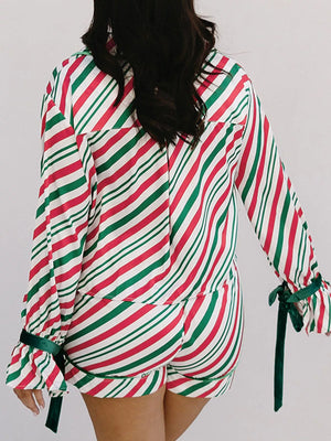 Velvet ribbon knot pajama set in stripe pattern with buttoned top and ruffled cuffs.