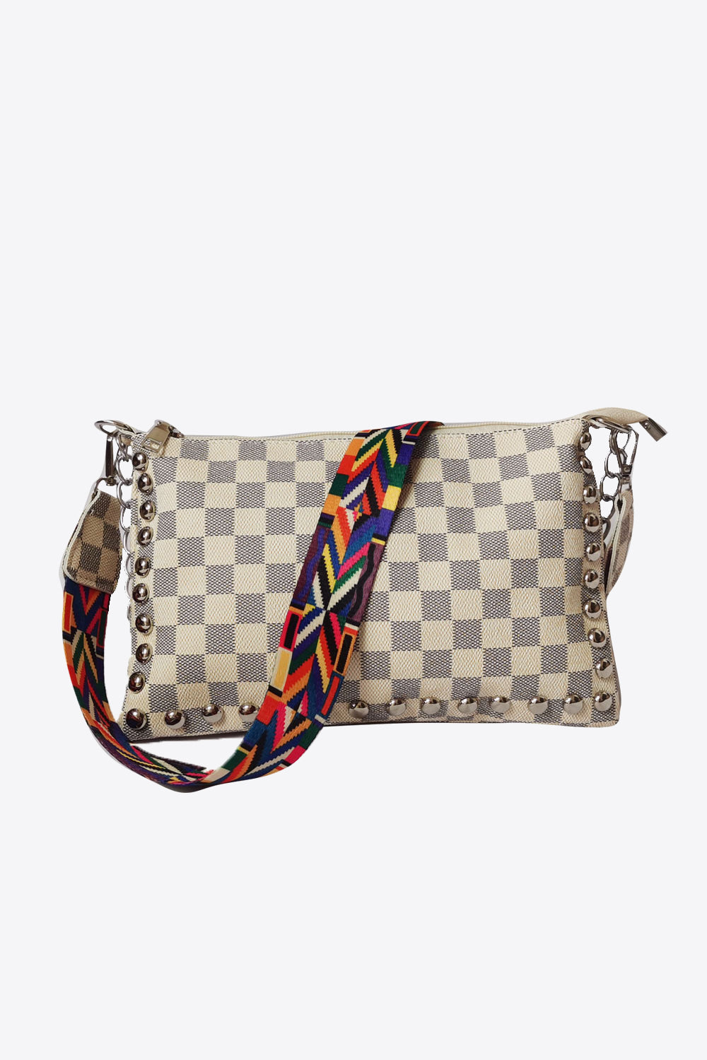 Ivory checkered shoulder bag with studded trim and a colorful patterned strap.
