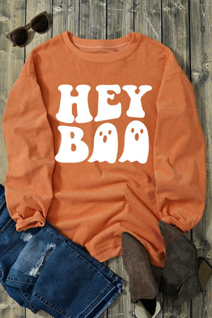 Orange corduroy sweatshirt with white Hey Boo ghost graphic and crewneck.