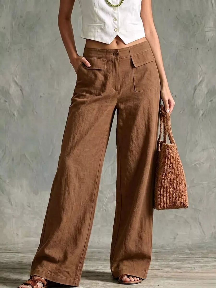 Brown linen wide-leg pants with flap pockets and a button closure.