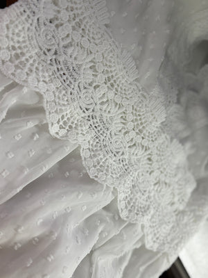 White textured fabric with lace trim